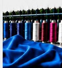 Spools of thread and blue fabric